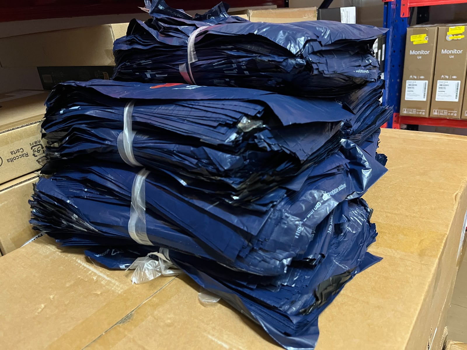 Stack of lazada pouches on a cardboard surface with boxes in the background