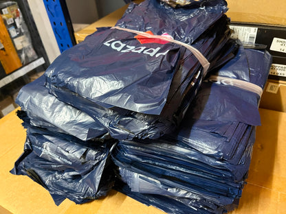 Stack of lazada pouches on a cardboard surface with boxes in the background